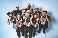 a group of people wearing t - shirts posing for a photo
